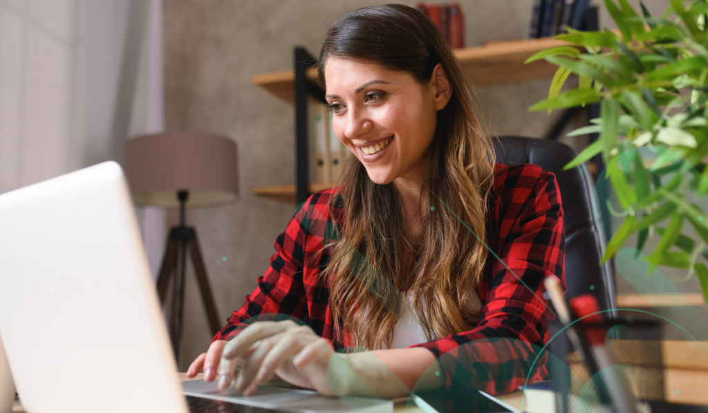 Lady working on a laptop remotely from home office.